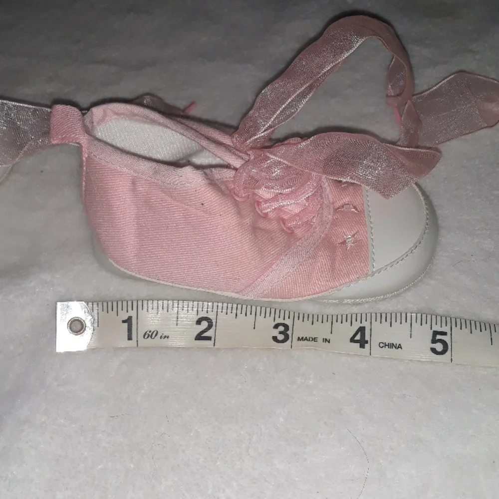 Pink baby sneakers with moon and star beaded accents and fun laces